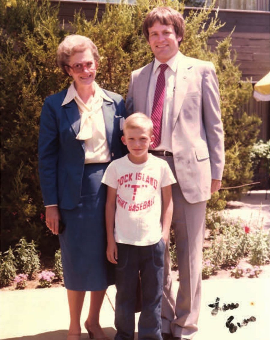 1983 photo: young Devin Hansen in a baseball T-shirt with his grandmother Catherine and Lane Evans, standing outdoors.